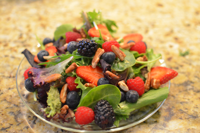greens with berries and pecans
