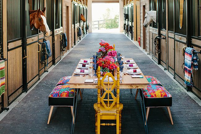 A table set in the horse barn for the dinner party