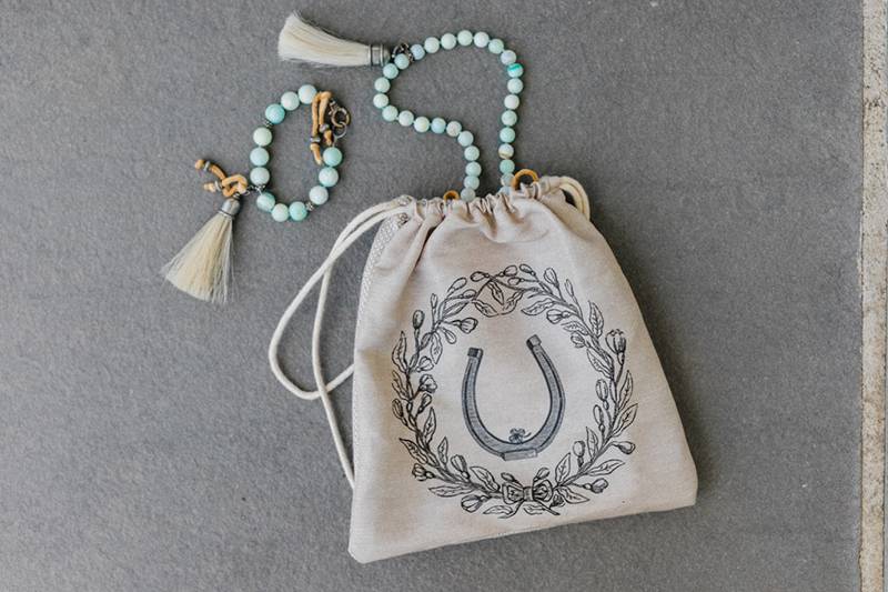 Horseshoe bag with green necklace
